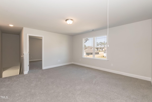 unfurnished room featuring carpet floors, baseboards, and recessed lighting