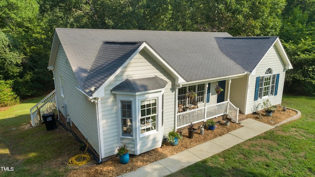 view of front of home featuring a porch and a front yard