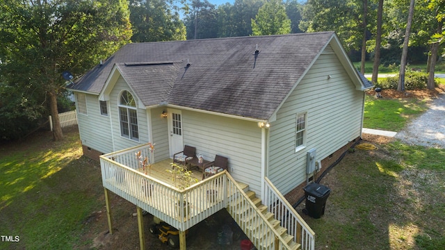 rear view of house featuring a deck