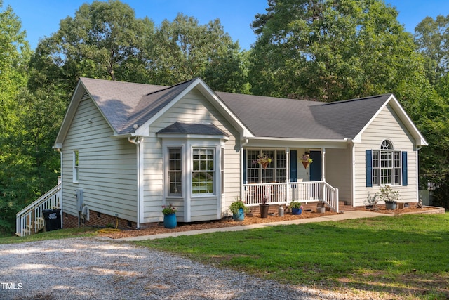 ranch-style house with a porch and a front lawn