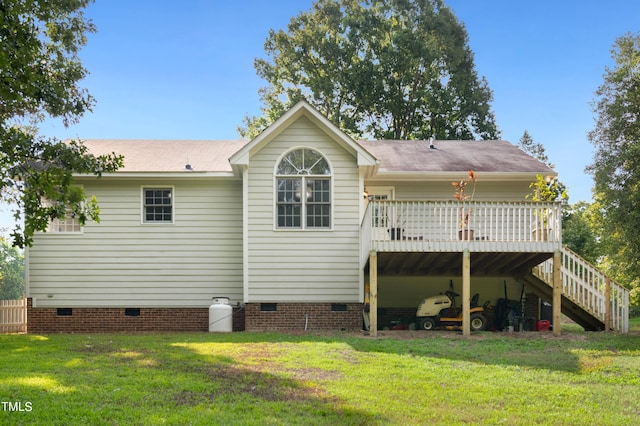 back of property with a wooden deck and a lawn