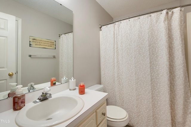 bathroom featuring vanity, toilet, and a textured ceiling