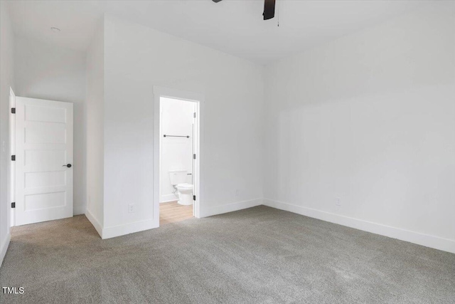 unfurnished bedroom featuring ensuite bathroom and carpet floors