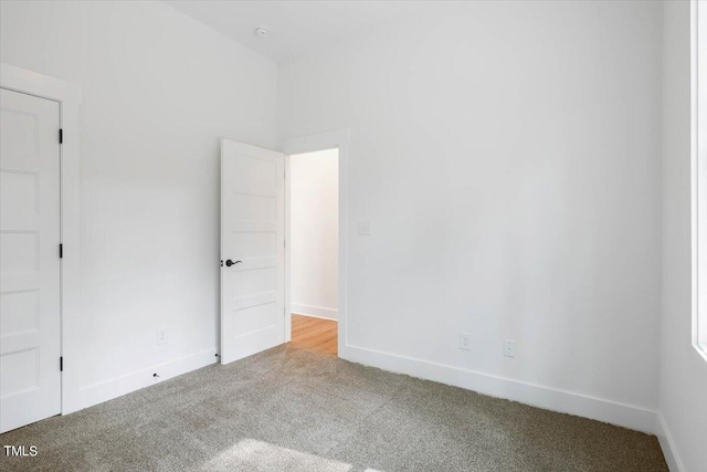 unfurnished room featuring light colored carpet