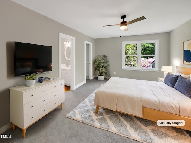 bedroom with baseboards, ensuite bath, carpet flooring, and a sink