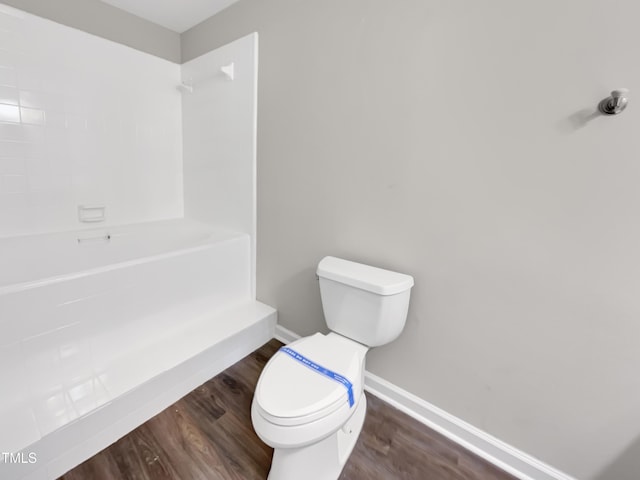 full bathroom with baseboards, toilet, wood finished floors, and a shower