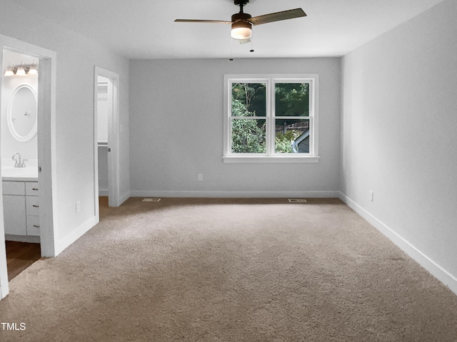 1432 Quarter Pt, Raleigh, NC 27615 - unfurnished bedroom with a walk in closet, carpet, connected bathroom, and a ceiling fan