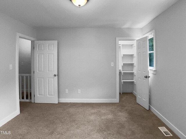 1432 Quarter Pt, Raleigh, NC 27615 - unfurnished bedroom featuring carpet flooring, a spacious closet, and a closet