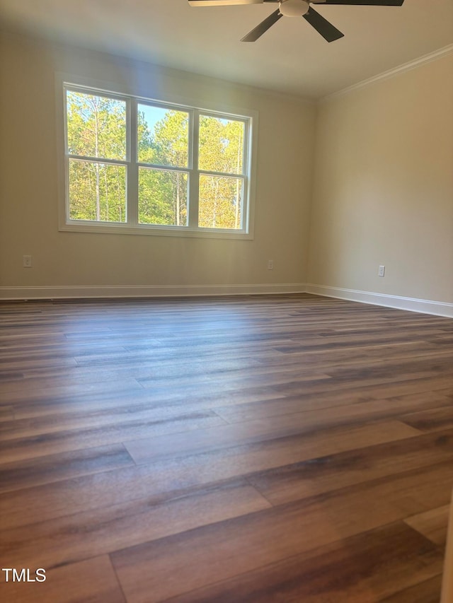 unfurnished room with crown molding, ceiling fan, and dark hardwood / wood-style flooring