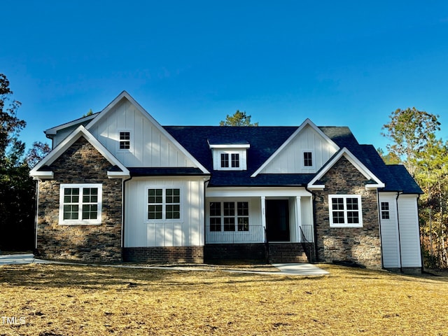 view of front of home featuring covered porch and a front yard