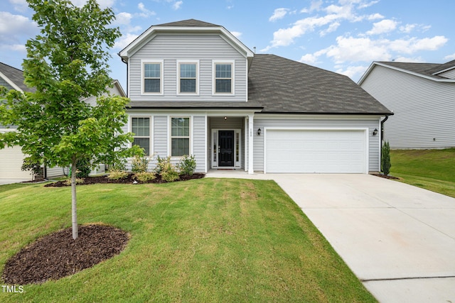 view of front of house with a garage and a front yard