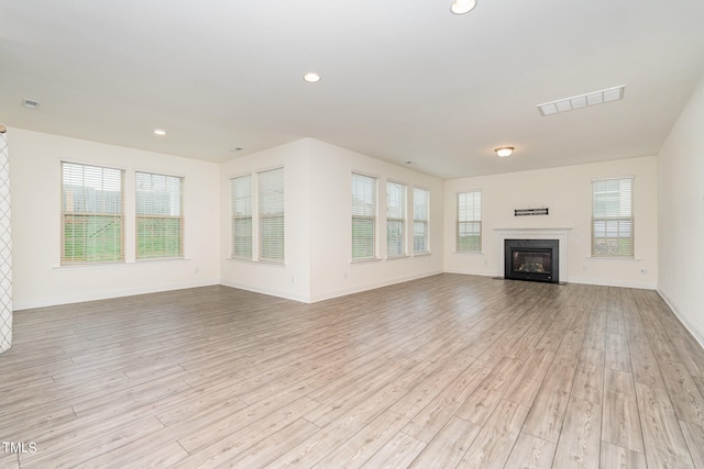 unfurnished living room with light hardwood / wood-style flooring