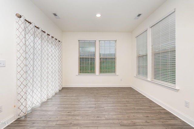 empty room with light hardwood / wood-style flooring