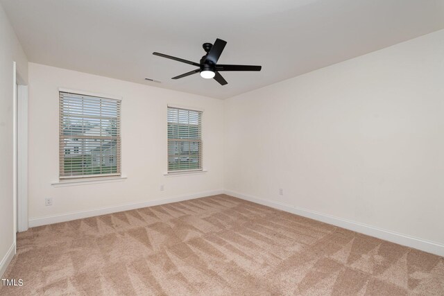 empty room with light colored carpet and ceiling fan