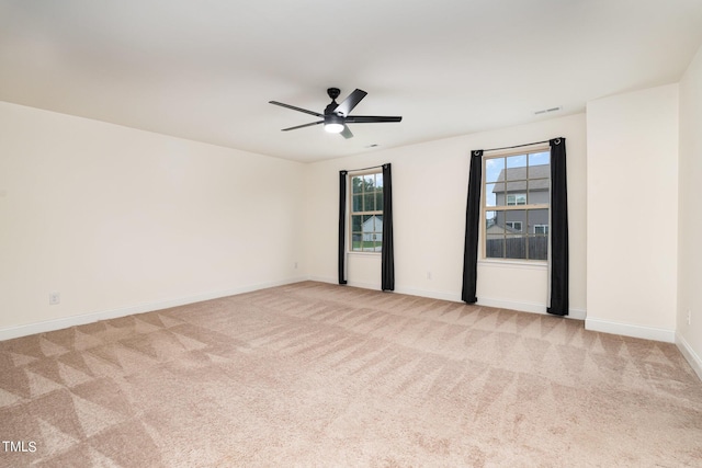 spare room with light carpet and ceiling fan