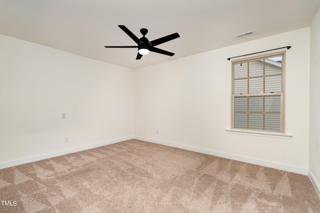 spare room with carpet and ceiling fan