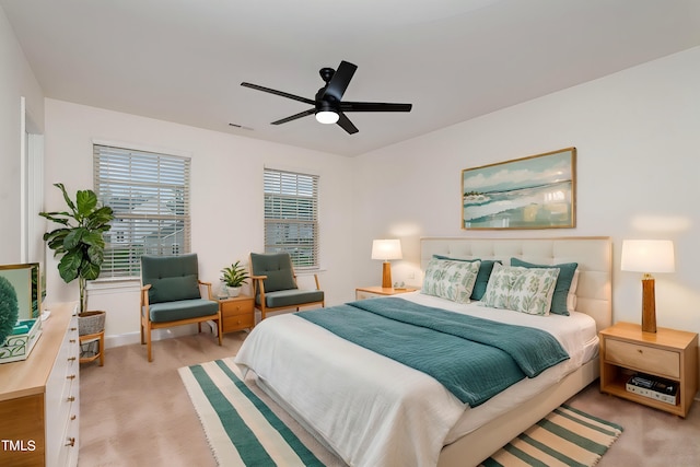 bedroom with light colored carpet and ceiling fan