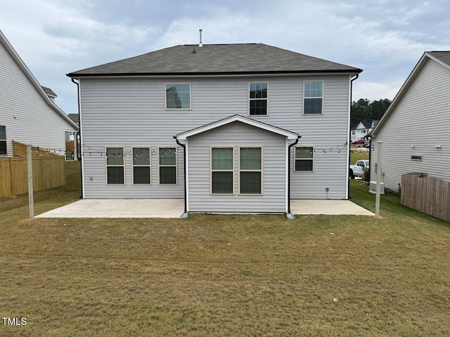 back of house featuring a patio and a yard