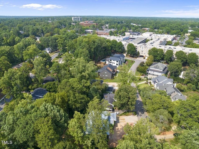 birds eye view of property with a view of trees