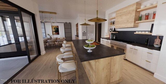 kitchen featuring white cabinetry, a barn door, an island with sink, built in features, and pendant lighting