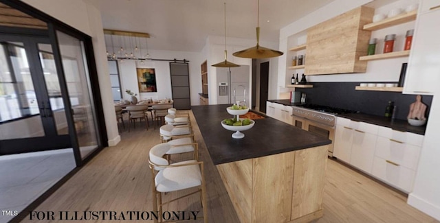 kitchen with dark countertops, a barn door, open shelves, and a kitchen breakfast bar