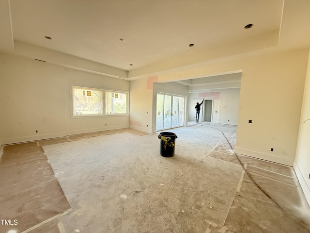 spare room with a tray ceiling