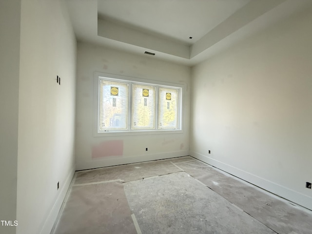 spare room featuring a raised ceiling