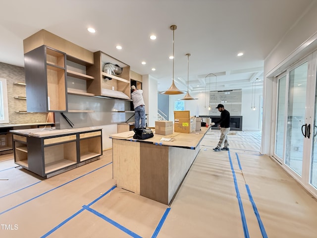 kitchen with a center island, open shelves, recessed lighting, light countertops, and decorative backsplash