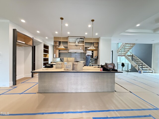 kitchen with a spacious island, decorative light fixtures, and recessed lighting