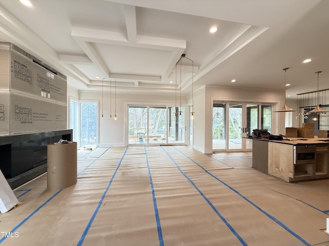 living room featuring coffered ceiling, a wealth of natural light, and recessed lighting