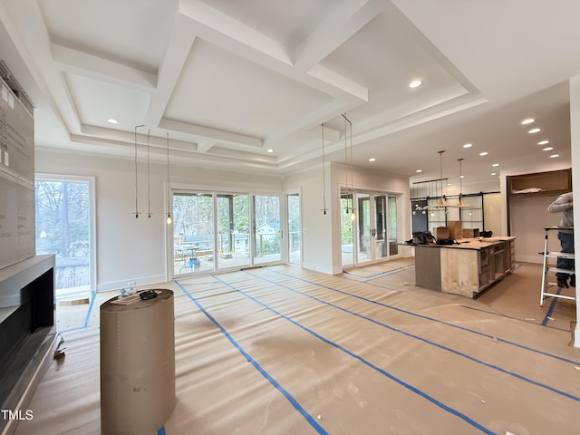 kitchen featuring open floor plan, coffered ceiling, a kitchen island, and a wealth of natural light