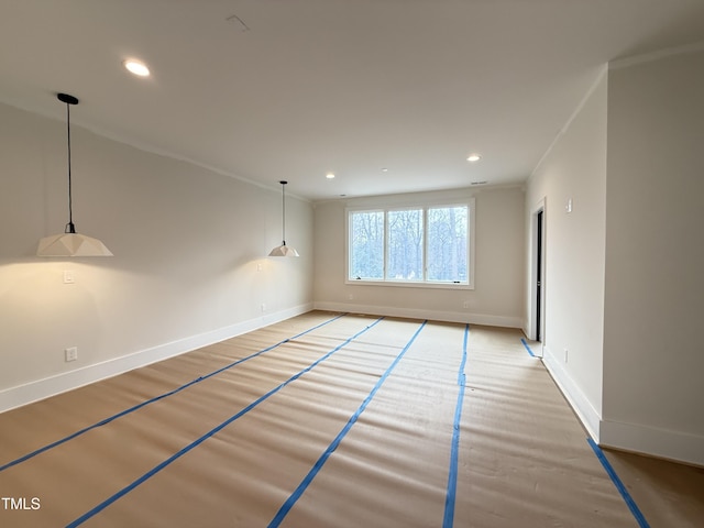 spare room with ornamental molding, recessed lighting, wood finished floors, and baseboards