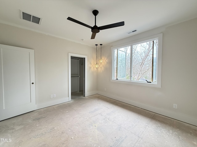 spare room featuring visible vents, ceiling fan, and baseboards