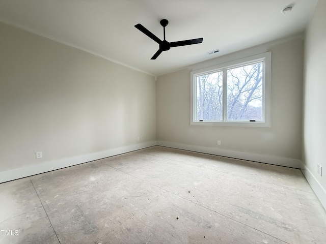 empty room with ceiling fan, visible vents, and baseboards