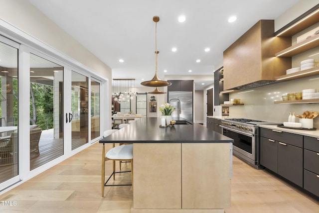 4123 Rockingham Dr, Raleigh, NC 27609 - kitchen featuring high quality appliances, open shelves, light wood-style flooring, a kitchen breakfast bar, and a kitchen island with sink