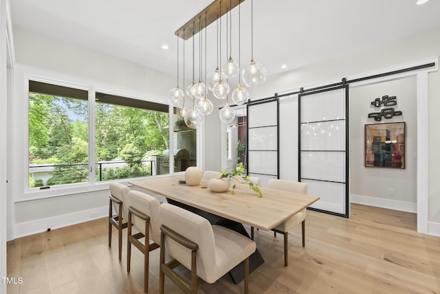 4123 Rockingham Dr, Raleigh, NC 27609 - dining room featuring a barn door, baseboards, light wood-style flooring, and recessed lighting
