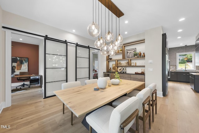 4123 Rockingham Dr, Raleigh, NC 27609 - dining space featuring a barn door, light wood finished floors, a desk, and recessed lighting