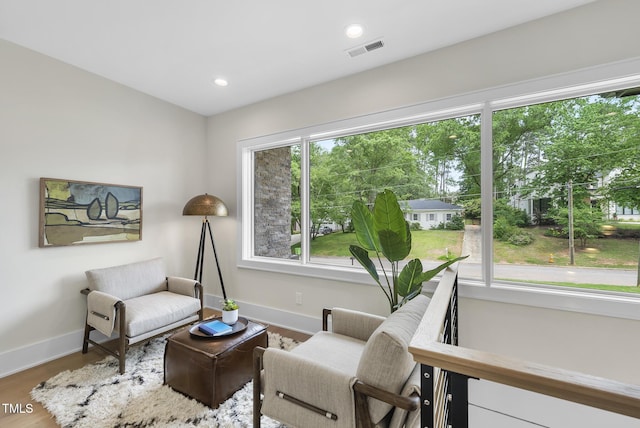 4123 Rockingham Dr, Raleigh, NC 27609 - sitting room featuring baseboards, wood finished floors, recessed lighting, and view of wooded area