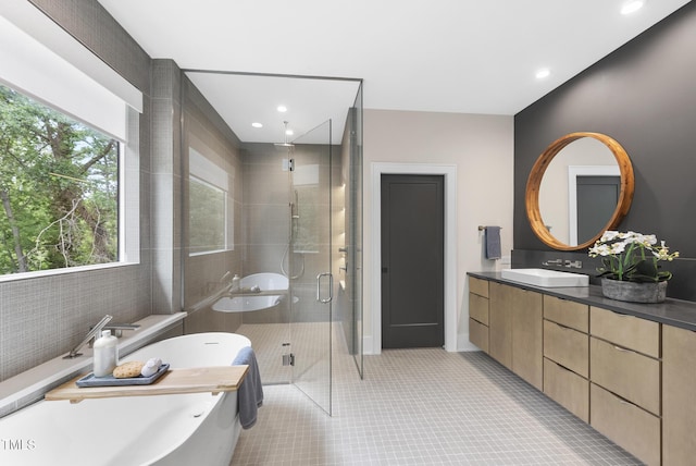 4123 Rockingham Dr, Raleigh, NC 27609 - full bath with a shower stall, vanity, tile patterned flooring, a freestanding tub, and recessed lighting
