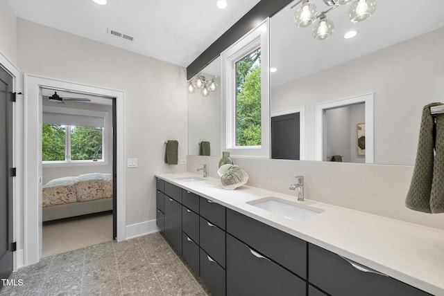 4123 Rockingham Dr, Raleigh, NC 27609 - ensuite bathroom featuring double vanity, recessed lighting, a chandelier, and baseboards