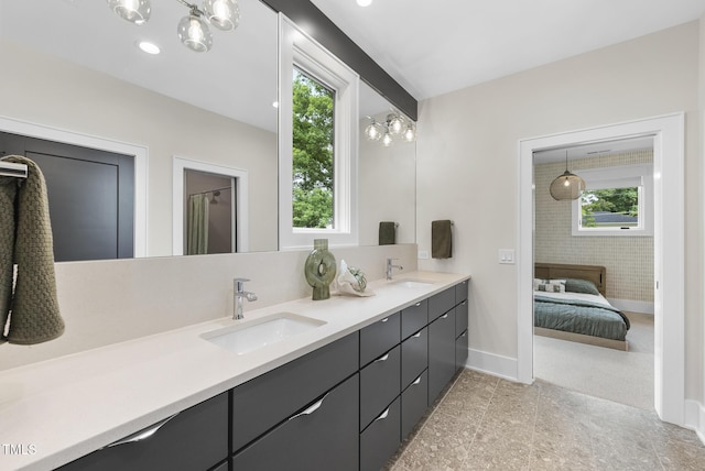 4123 Rockingham Dr, Raleigh, NC 27609 - bathroom featuring double vanity and baseboards