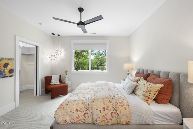 4123 Rockingham Dr, Raleigh, NC 27609 - bedroom featuring carpet, a walk in closet, baseboards, a ceiling fan, and a closet