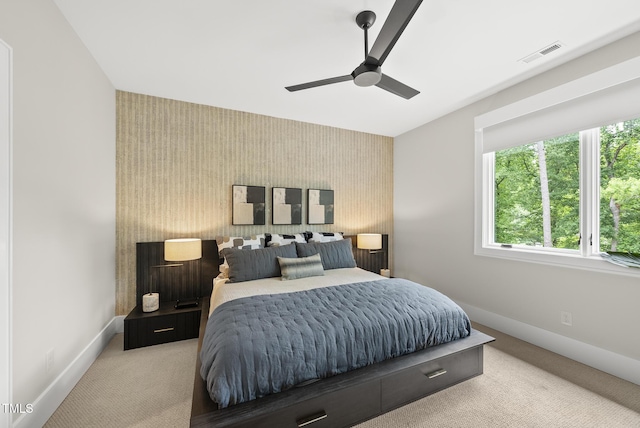 4123 Rockingham Dr, Raleigh, NC 27609 - bedroom with an accent wall, wallpapered walls, baseboards, light colored carpet, and a ceiling fan