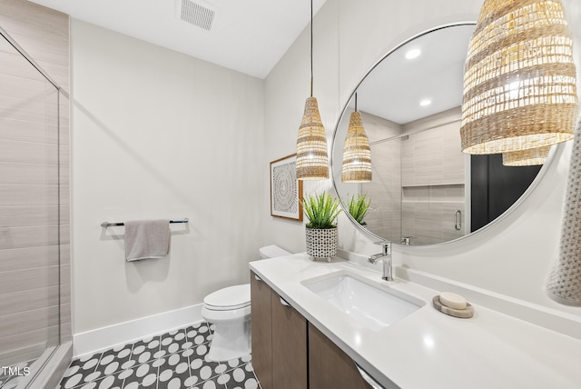 4123 Rockingham Dr, Raleigh, NC 27609 - full bathroom with baseboards, a stall shower, toilet, vanity, and recessed lighting
