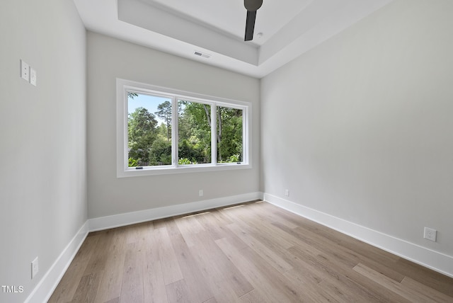 4123 Rockingham Dr, Raleigh, NC 27609 - empty room featuring wood finished floors, baseboards, a tray ceiling, and ceiling fan