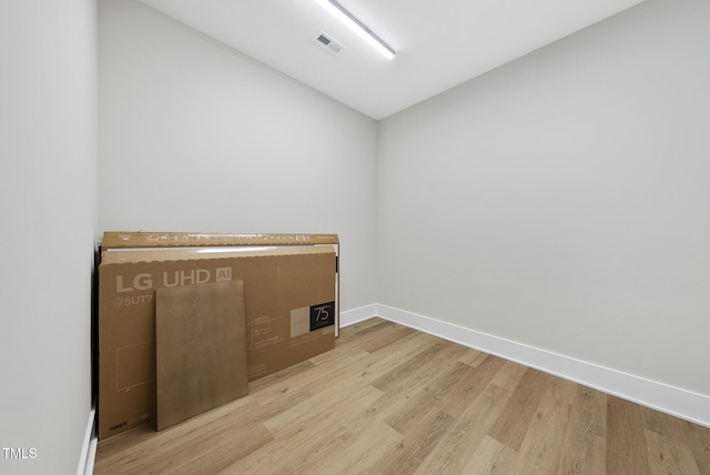 4123 Rockingham Dr, Raleigh, NC 27609 - empty room with light wood-type flooring, vaulted ceiling, and baseboards