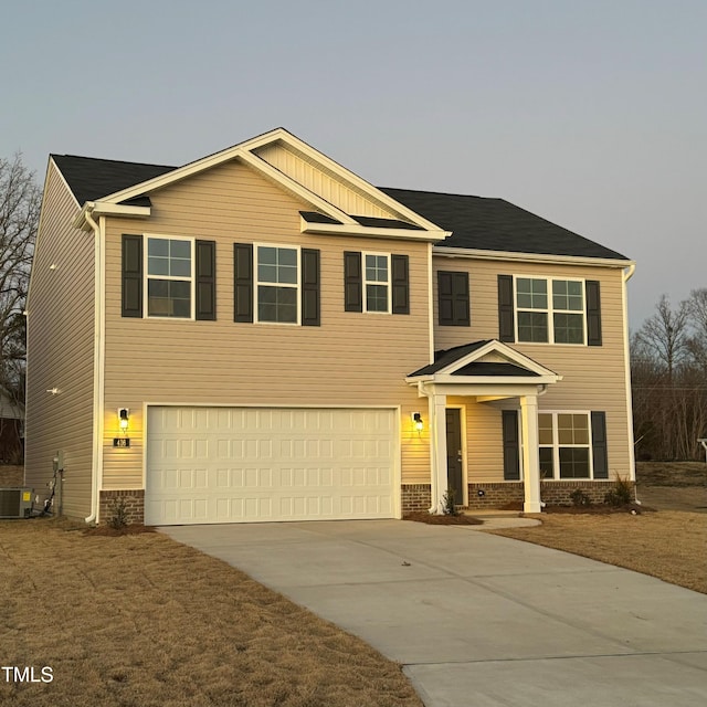 view of front facade featuring cooling unit and a garage