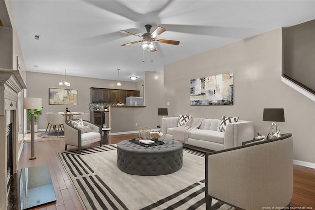 living room with wood-type flooring and ceiling fan