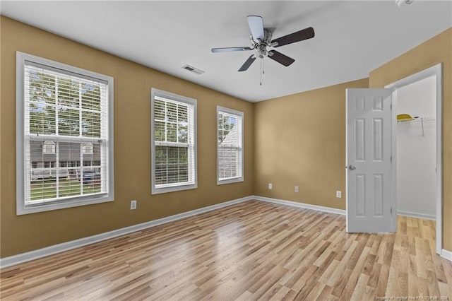 unfurnished room with ceiling fan and light hardwood / wood-style floors