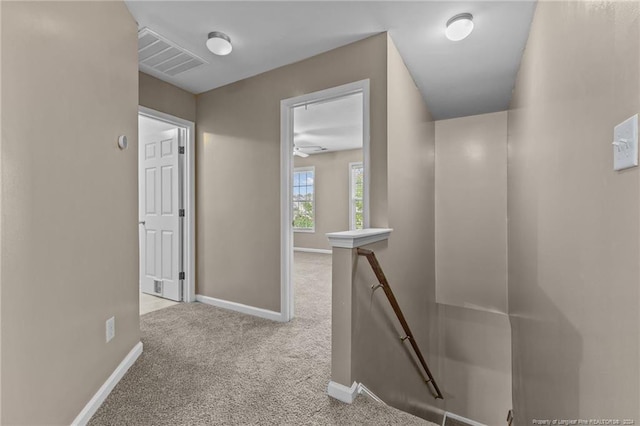 hallway with light colored carpet